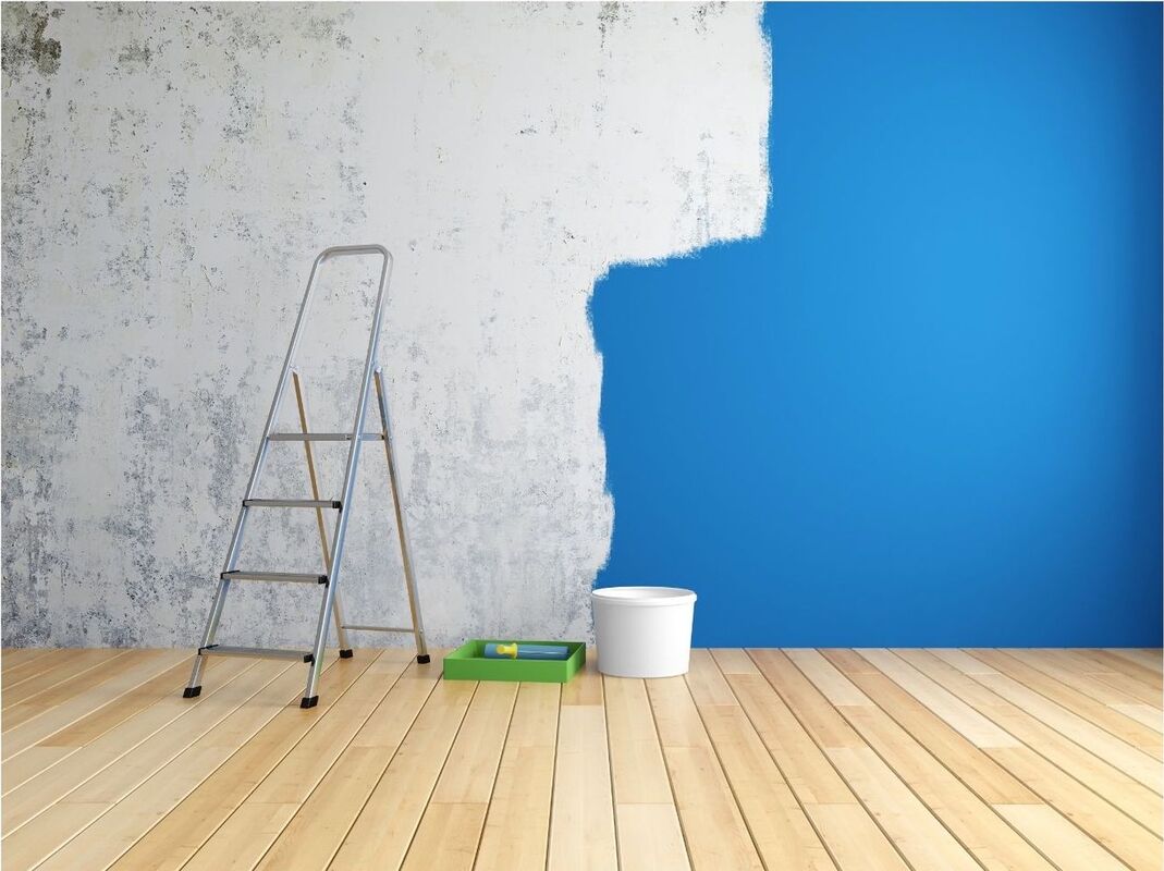 A room with light wooden flooring and a step ladder, paint pot and tray on the floor. The wall in the background is half painted blue on the right and grey on the left.